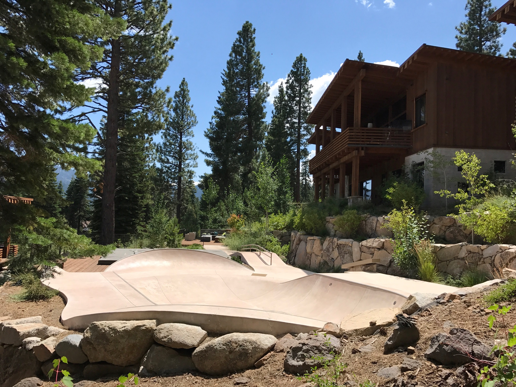 Custom backyard concrete skate mini ramp and pool setup